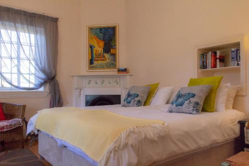 a bedroom with a bed with pillows and a fireplace at The Cherry Stone Country House in Fouriesburg