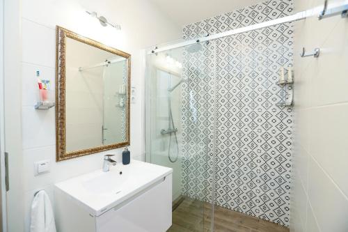 a bathroom with a shower and a sink and a mirror at D8 Design Apartment & Studio in Eger