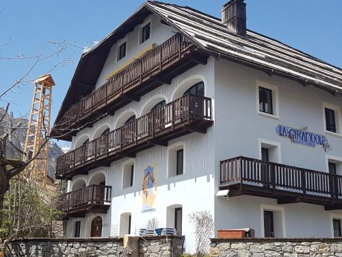 a white building with balconies on the side of it at La Girandole Chambre d'hôtes et Location d'appartement in Arvieux