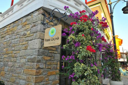 a building with flowers on the side of it at Petrino Gökçeada Hotel&Kitchen in Gokceada Town