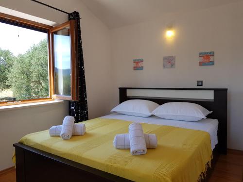 a bedroom with a bed with towels on it at Holiday Home Strpuncina in Luka