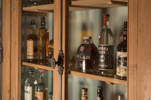 a cabinet filled with lots of bottles of alcohol at Bungalows Key Largo - All Inclusive in Key Largo