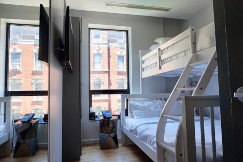 a bedroom with two bunk beds and a window at The Ridge in New York
