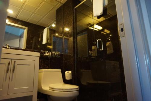 a bathroom with a toilet and a glass shower at The Ridge in New York