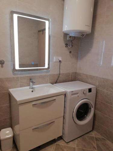 a bathroom with a washing machine and a sink at Apartment Marko in Rovinjsko Selo