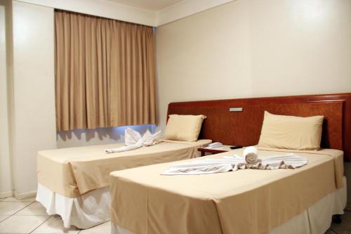 Una cama o camas en una habitación de Hotel Minuano