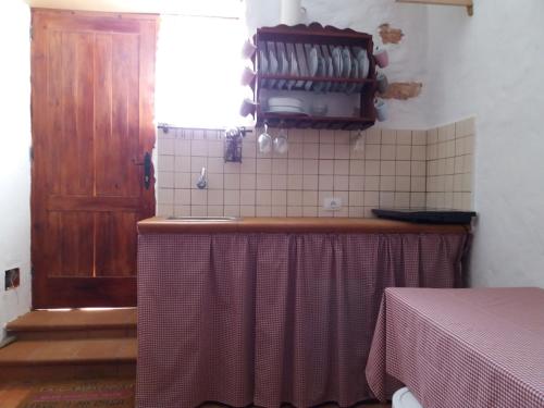 a kitchen with a counter with a sink and a window at Casita rural Molino de La Corte in Antigua