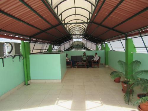an office with two people sitting at a table in a building at Alojamiento El Cardenal in Iquitos