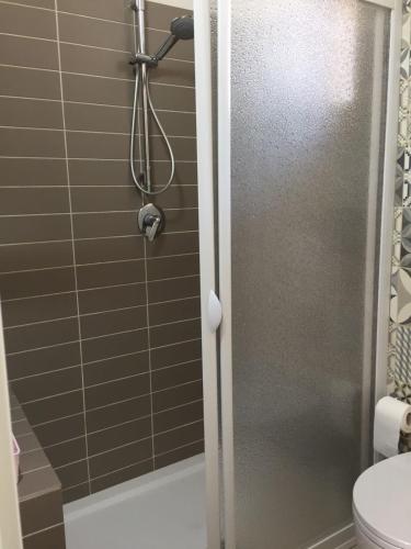a shower with a glass door in a bathroom at Casa le Gebbie in Marzamemi