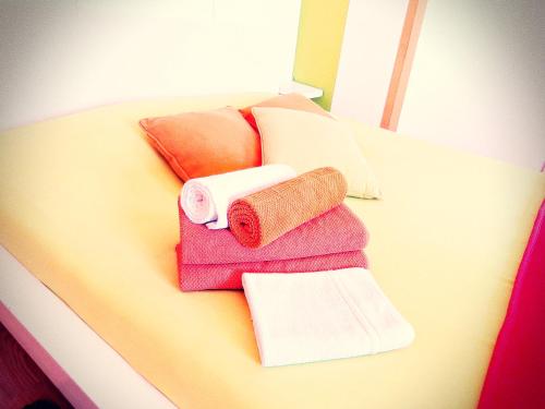 a pile of towels sitting on top of a table at Residencia Praia Norte - AL in Nazaré
