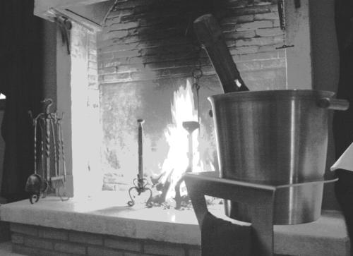 a brick oven with a fire in it at Damaranto Residenza e Cucina in Soave