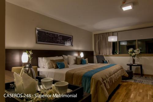 a hotel room with a large bed in a room at Caseros 248 Hotel in Cordoba