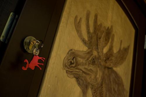 a door with a picture of a deer on it at Łosia Chata in Grzybowce