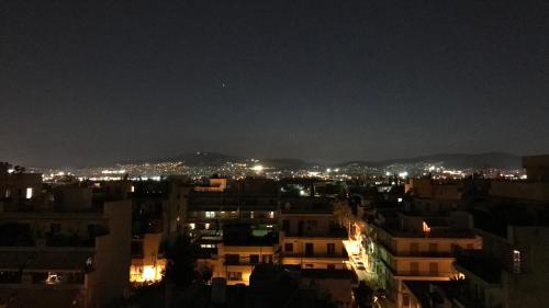 a view of a city at night at Penthouse - Center of Athens in Athens