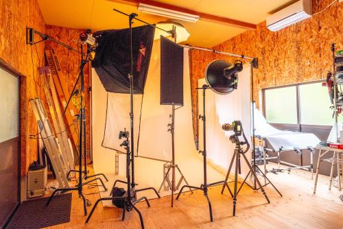 a recording studio with several cameras in a room at Share Creative&Bed adonoan in Takeo