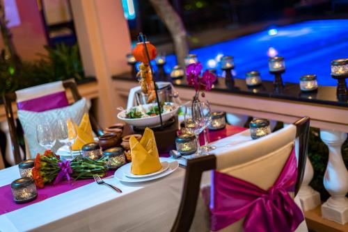 a table with a table set up for a party at Allegro Hoi An . A Little Luxury Hotel & Spa in Hoi An