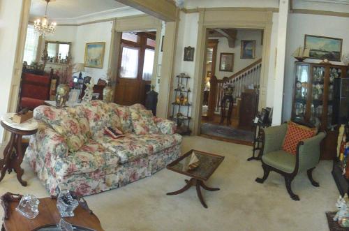 a living room with a couch and a chair at Wilson House Bed & Breakfast in Baltimore