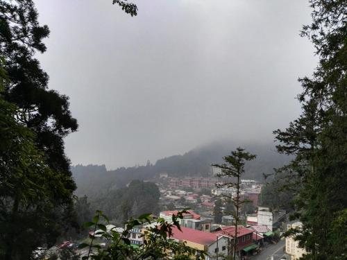 a view of a city from a mountain at Qun Feng Hotel in Fenchihu