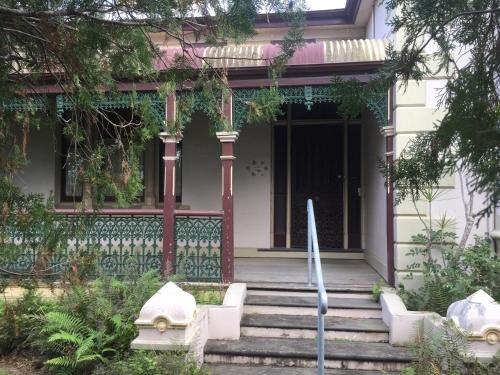 a house with stairs leading to a door at Rosslyn in Grafton