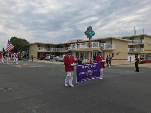 a group of people holding a sign in the street at Seahorse Inn in Wildwood