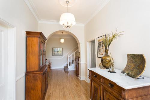 a hallway with a table and a vase at Palmyra B&B in Rainbow Flat