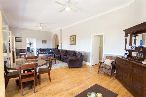 a living room with a couch and a table at Palmyra B&B in Rainbow Flat