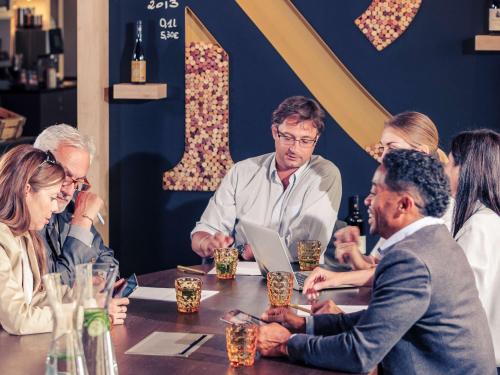 a group of people sitting around a table at Mercure München City Center in Munich