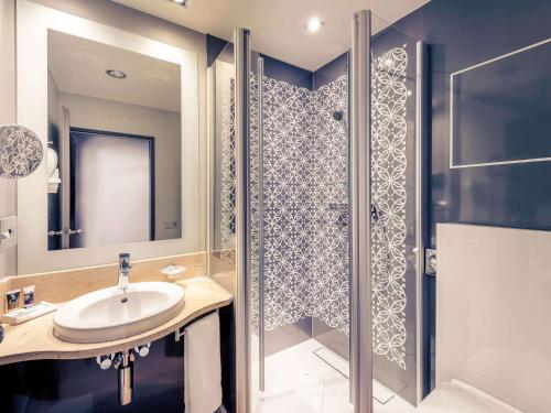 a bathroom with a sink and a shower at Mercure München City Center in Munich