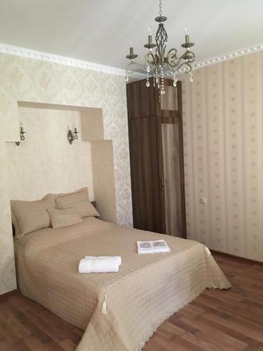 a bedroom with a bed with two towels on it at Apartment Barita in Tbilisi City