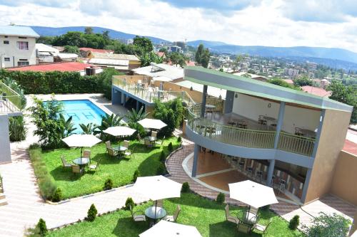 an aerial view of a hotel with a pool and tables and umbrellas at Lebanon Hotel in Kigali