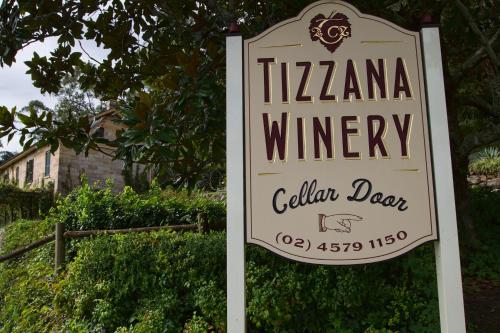 a sign for a winery in front of a house at Tizzana Winery Bed and Breakfast in Sackville Reach
