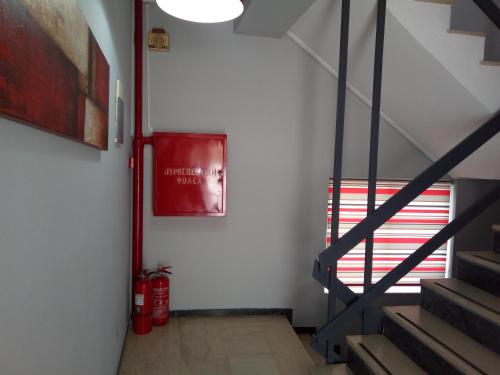 a hallway with stairs and a poster on the wall at Zappion Hotel in Athens
