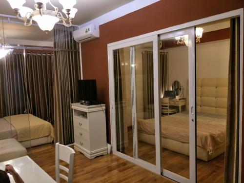 a bedroom with a bed and a mirror at Nancy Vung Tau in Vung Tau