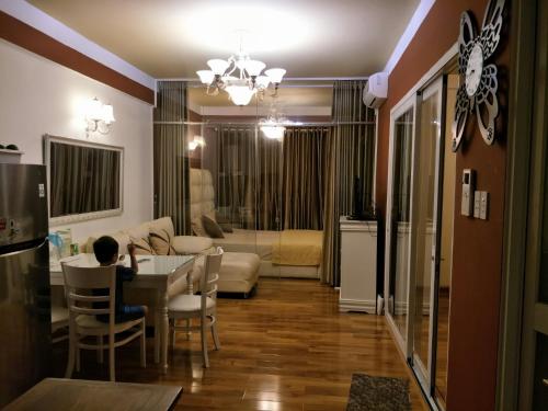a person sitting at a table in a living room at Nancy Vung Tau in Vung Tau