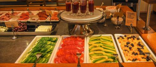 a buffet with different types of vegetables in trays at Best Western Plus Grand Hotel Elektra in Ludvika