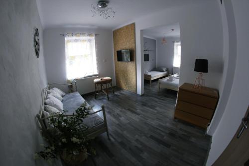 a living room with a couch and a table at Folwark Anna in Kamienica Polska
