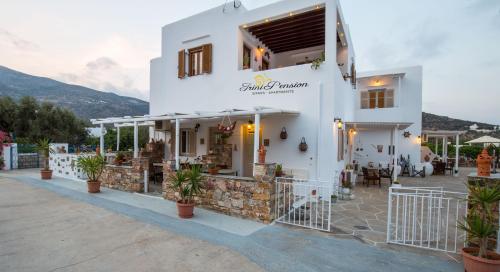 a white building with plants in front of it at Irini pension in Platis Yialos Sifnos