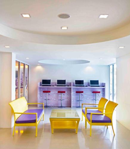 a waiting room with two chairs and a table at Samui Verticolor in Chaweng