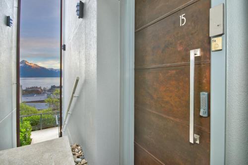 a door to a house with a view of a mountain at Luxury on the Lake in Queenstown