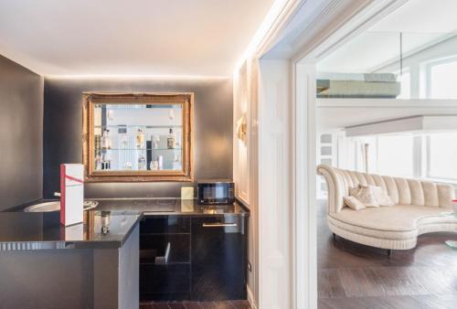 a living room with a couch and a mirror at TOP Luxury Suites in Budapest