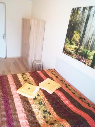 a bedroom with a bed with two towels on it at Couple getaway to a freshly renovated apartment in Pärnu