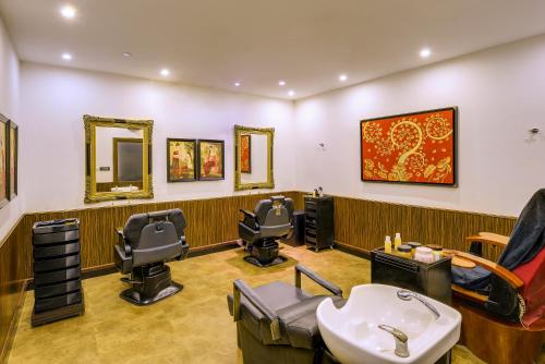a hair salon with three barber chairs and a sink at Mayfair Waves in Puri