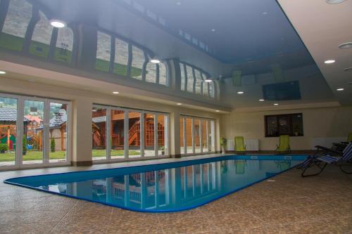 a large swimming pool in a building with a ceiling at Family Hotel Cascad in Bukovel