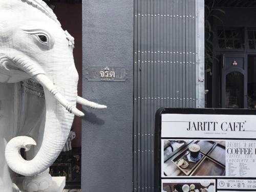 a statue of an elephant standing next to a sign at JARITT NyMMANH in Chiang Mai