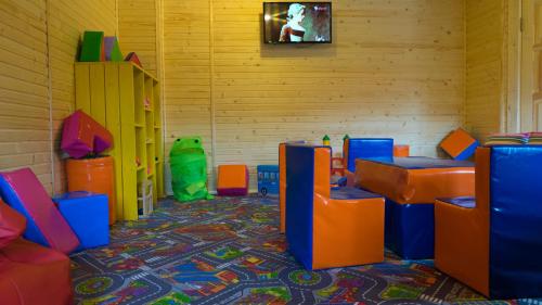 a room with colorful chairs and a tv on the wall at Family Hotel Kaskad in Bukovel