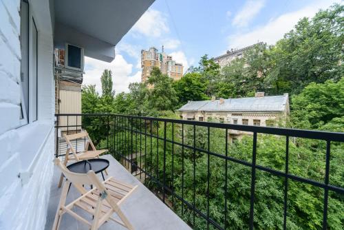 a chair sitting on a balcony with a view at Partner Guest House in Kyiv