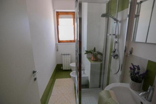 a bathroom with a shower and a toilet and a sink at S'Alighera Guest House in Alghero