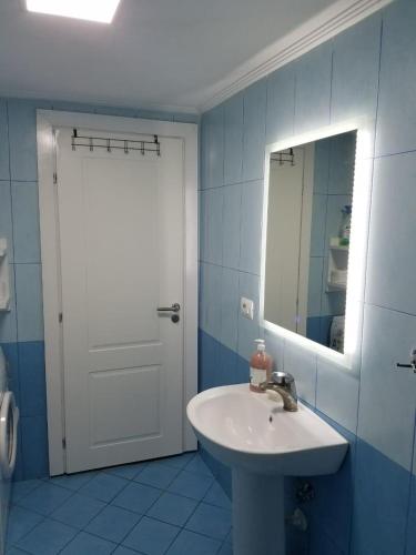 a bathroom with a white sink and a mirror at Luxury duplex Armand Durres in Golem