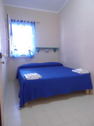 Voodi või voodid majutusasutuse Appartamenti Teulada di Laura toas