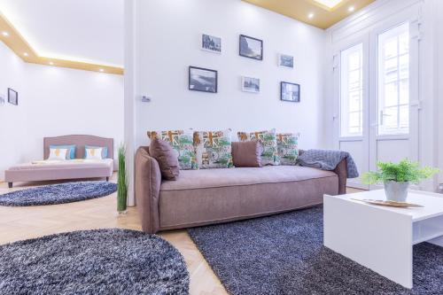 sala de estar con sofá y 2 alfombras en Real Apartments Zoltán en Budapest